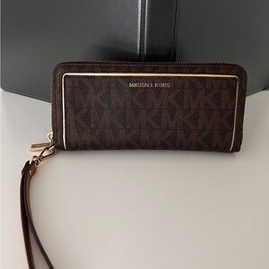 Michael Kors Dark Brown Monogram Wristlet with gold tone accents